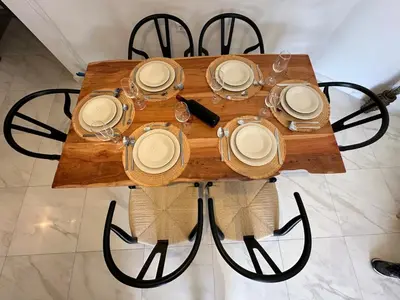 a wooden table with plates and glasses on it at Melina's house in Skinés