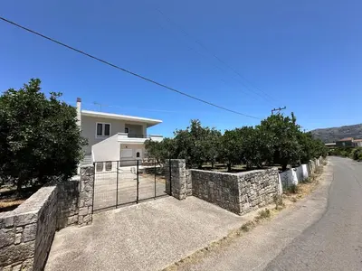 a stone fence in front of a house at Melina's house in Skinés