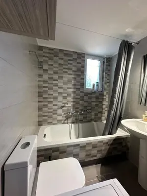 a bathroom with a tub and a toilet and a sink at Melina's house in Skinés