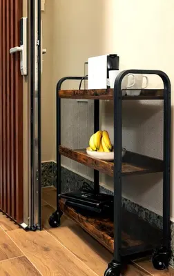 a shelf with a plate of bananas on it at Raviewha Luxury Apartments 2 in Ravdhoúkha