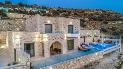 a large stone house with a swimming pool at Nafsika Xenia - Odysseus in Falasarna