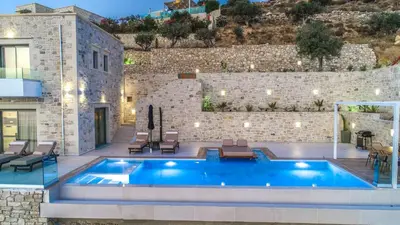 a swimming pool in front of a building at Nafsika Xenia - Odysseus in Falasarna