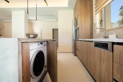 a laundry room with a washing machine in a kitchen at Villa George in Límni
