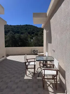 a patio with a table and chairs on a building at Petra Homes Temenia in Teménia