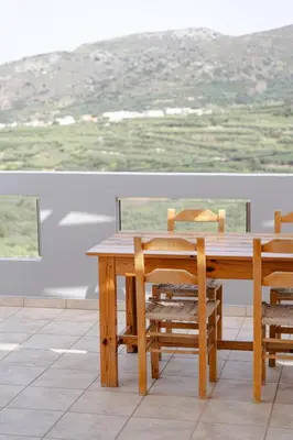 a wooden table and chairs with a view at Villa Avelios in Karefilianá