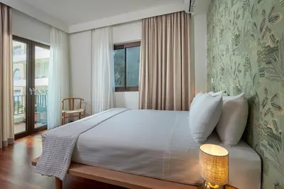 a bedroom with a large bed and a window at Katsambas Apartment - Cozy Retro-Luxury with Balcony in Chania Town
