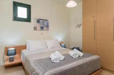 a bedroom with a bed with towels on it at Casa Barbara in Stalos