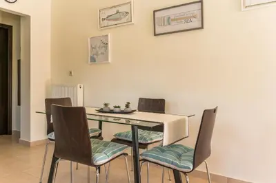 a dining room with a table and chairs at Casa Barbara in Stalos