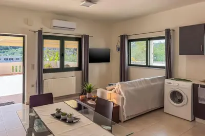 a living room with a couch and a table at Casa Barbara in Stalos