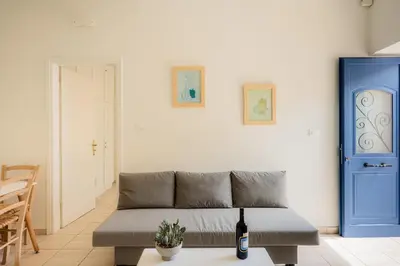 a living room with a couch and a blue door at Bella Apartment in Chania Town