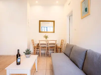 a living room with a couch and a table at Bella Apartment in Chania Town