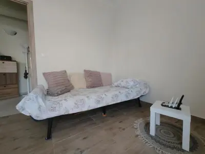 a couch with two pillows on it in a living room at Lumen Chania in Chania Town