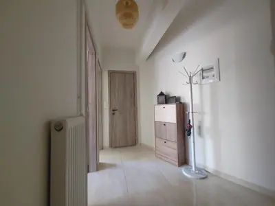 a room with a hallway with a dresser and a door at Lumen Chania in Chania Town