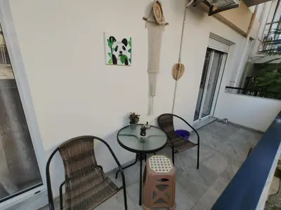 a patio with a table and chairs in a room at Lumen Chania in Chania Town