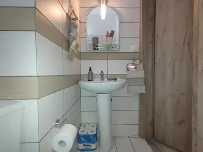 a bathroom with a sink and a mirror at Lumen Chania in Chania Town