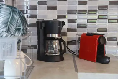 a coffee maker sitting on a counter next to a toaster at Tzei House - 5min drive to beach in Perivólia