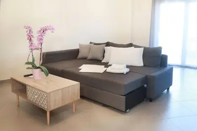 a living room with a couch and a coffee table at Tzei House - 5min drive to beach in Perivólia