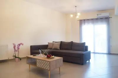 a living room with a couch and a coffee table at Tzei House - 5min drive to beach in Perivólia