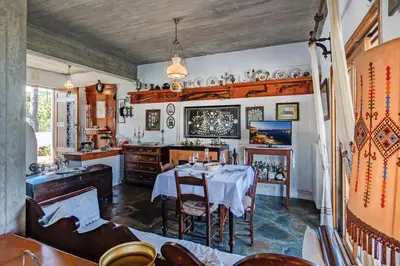 a dining room with a table and chairs at Lilly Traditional Cretan Villa in Dhrakóna