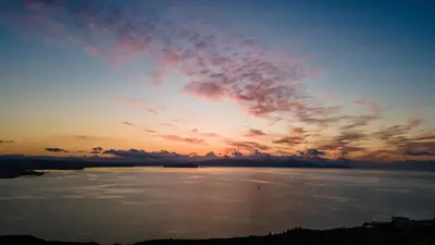 a sunset over a large body of water at Be Crete - Horizon in Chania Town