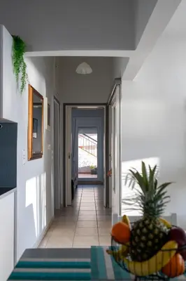 a hallway with a table with a bowl of fruit on it at Be Crete - Horizon in Chania Town
