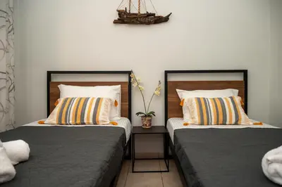 two beds sitting next to each other in a bedroom at Be Crete - Horizon in Chania Town