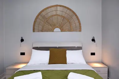 a bedroom with a bed with a rattan headboard at El Dorado Corner with Hot Tub in Chania Town