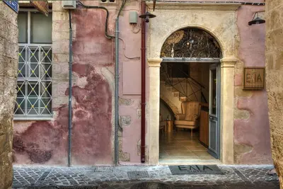 an entrance to a pink building with an open door at Elia Zampeliou Hotel in Chania Town