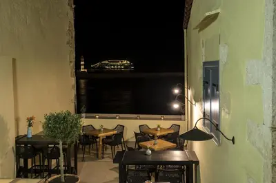 a room with tables and chairs and a window at Elia Zampeliou Hotel in Chania Town