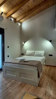 a bedroom with a large bed in a room at Mposkini house - next to Chania town center in Chania Town