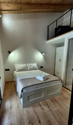 a bedroom with a large bed and a loft at Mposkini house - next to Chania town center in Chania Town