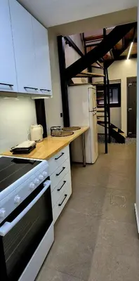 a kitchen with white cabinets and a stove top oven at Mposkini house - next to Chania town center in Chania Town