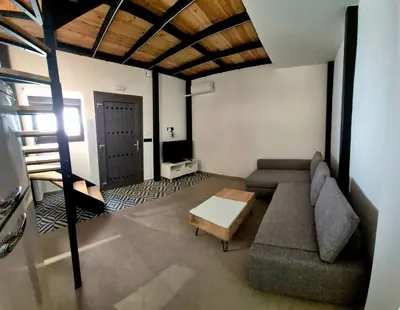 a living room with a couch and a table at Mposkini house - next to Chania town center in Chania Town