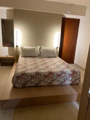 a bedroom with a large bed with two pillows at Saxon's Corner in Chania Town