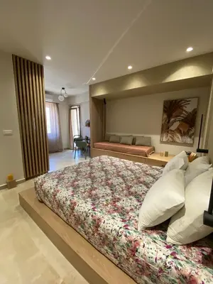 a large bedroom with a large bed and a couch at Saxon's Corner in Chania Town