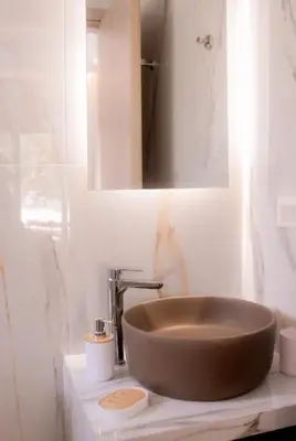 a bathroom sink with a large brown bowl at Luxury apartment Reverie in Sfakiá