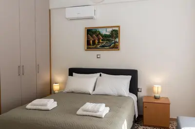 a bedroom with a bed with two towels on it at Lumea Apartment in Chania Town