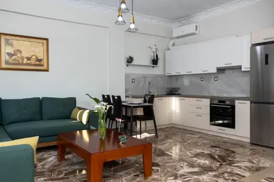 a living room with a couch and a table at Lumea Apartment in Chania Town