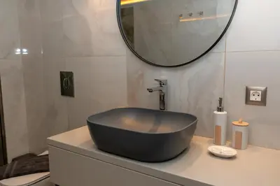 a black bowl sink on a counter in a bathroom at Lumea Apartment in Chania Town