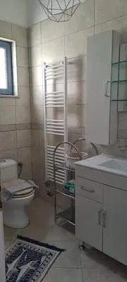 a bathroom with a toilet and a sink and a mirror at Villa Agassi Aspo Apokoronas Crete in Koprána