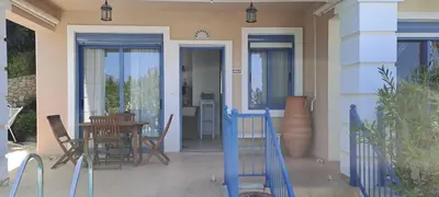 a house with a patio with a table and chairs at Villa Agassi Aspo Apokoronas Crete in Koprána