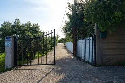a gate on a brick road with a fence at Chania Garden Retreat in Souda