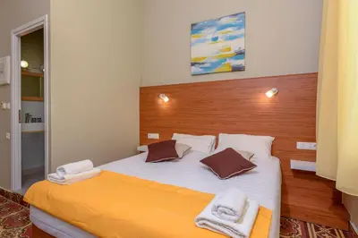 a bedroom with a large bed with two towels on it at TheJoy in Chania Town