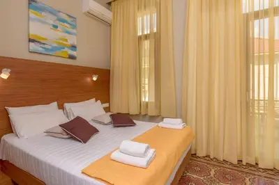 a bedroom with a bed with towels on it at TheJoy in Chania Town