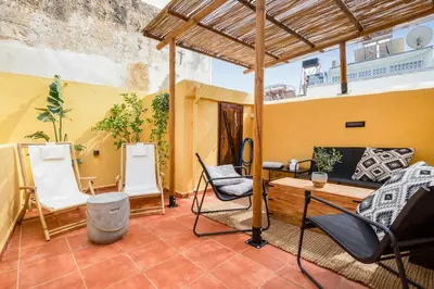 a patio with chairs and a table on a building at Maisonette in center of Chania with roofgarden! in Chania Town