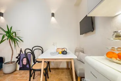 a small kitchen with a table and a dining room at Maisonette in center of Chania with roofgarden! in Chania Town
