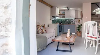 a living room with a couch and a table at Central old Town house with jacuzzi and yard,4ppl in Chania Town