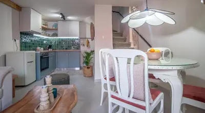 a kitchen with a table and chairs in a room at Central old Town house with jacuzzi and yard,4ppl in Chania Town