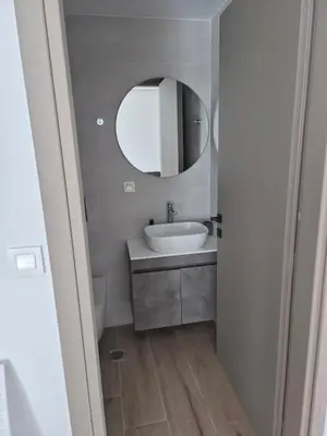 a bathroom with a sink and a mirror at Aldea Apartments in Palio Gerani