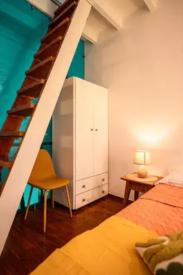 a bedroom with a staircase and a bed and a desk at Romantic Maisonette in Chania Town
